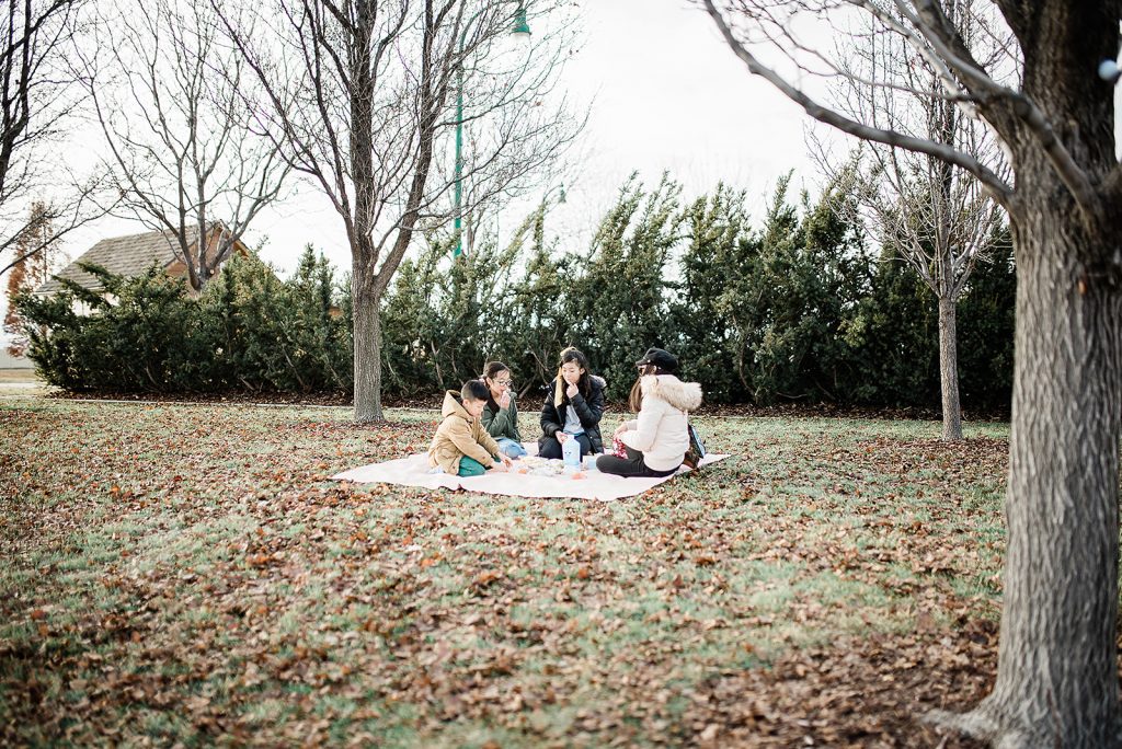 cute family having a picnic outside in the park