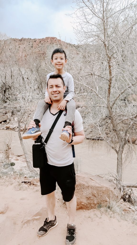 son on dad shoulder at Zion