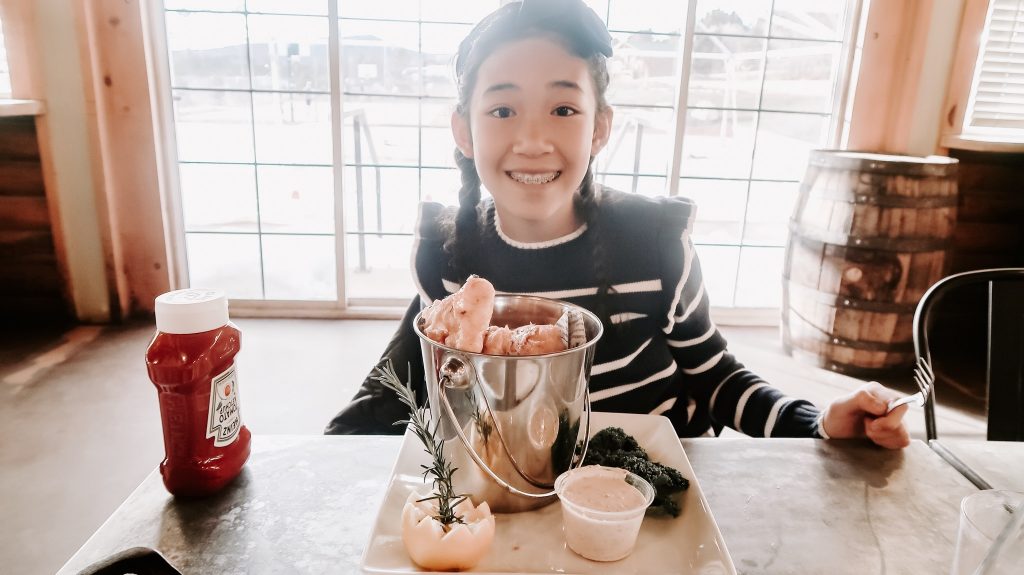 a girl smiling at zion ponderosa restaurant